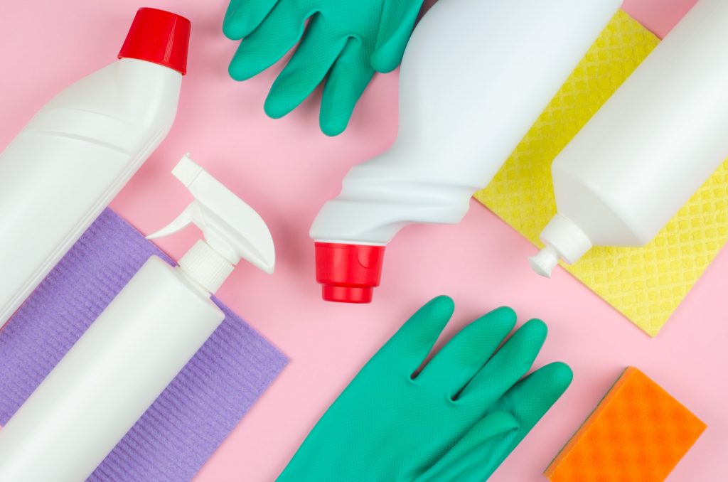 Cleaning products on a pink background.